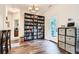 Comfortable dining area with ample natural light, built-in bookshelves, and stylish wood floors at 79 Little Creek Manor Dr, Dallas, GA 30157