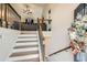 Bright entryway featuring stairs leading to a spacious living area with carpeted floors and a comfortable couch at 79 Little Creek Manor Dr, Dallas, GA 30157