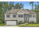 Charming two-story home featuring stone accents, blue shutters, manicured lawn, and a welcoming arched entryway at 79 Little Creek Manor Dr, Dallas, GA 30157