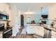 Bright kitchen featuring granite countertops, stainless steel appliances, and wood-look flooring at 79 Little Creek Manor Dr, Dallas, GA 30157
