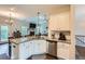 Open kitchen with white cabinetry, granite countertops, stainless steel appliances, and seamless transition to the living room at 79 Little Creek Manor Dr, Dallas, GA 30157