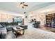 Open-concept living room flows into the kitchen, with vaulted ceilings and seamless flooring transition at 79 Little Creek Manor Dr, Dallas, GA 30157