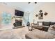 Inviting living room featuring a stone fireplace, large windows, and comfortable seating at 79 Little Creek Manor Dr, Dallas, GA 30157