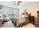 Serene main bedroom with a tray ceiling, plush carpet, and a view to the outside at 79 Little Creek Manor Dr, Dallas, GA 30157