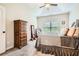 Comfortable main bedroom with neutral tones, a tray ceiling, and a window offering natural light at 79 Little Creek Manor Dr, Dallas, GA 30157