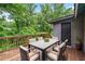 Inviting back deck with a dining table and chairs surrounded by lush greenery at 944 Deckner Sw Ave, Atlanta, GA 30310