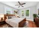 Bright bedroom with hardwood floors, ceiling fan, and natural light from large windows at 944 Deckner Sw Ave, Atlanta, GA 30310