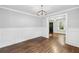 Elegant dining room features classic wainscoting, hardwood floors, and stylish light fixture at 944 Deckner Sw Ave, Atlanta, GA 30310
