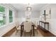 Formal dining area with natural light, wainscoting detail, and modern light fixture at 944 Deckner Sw Ave, Atlanta, GA 30310