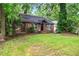Charming brick home with a well-manicured front lawn and mature trees at 944 Deckner Sw Ave, Atlanta, GA 30310