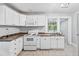 Well-lit kitchen with white cabinetry and appliances, providing a clean workspace at 944 Deckner Sw Ave, Atlanta, GA 30310