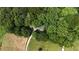Aerial view of the home nestled among mature trees and surrounded by lush greenery at 141 Mills Creek Path, Hiram, GA 30141