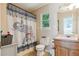 Bathroom with a decorative shower curtain, toilet, and cabinet with sink at 141 Mills Creek Path, Hiram, GA 30141