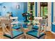 A dining area featuring blue walls, a glass table, and cushioned chairs at 141 Mills Creek Path, Hiram, GA 30141