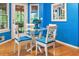 Bright dining area features blue walls and a glass-top table with cushioned chairs at 141 Mills Creek Path, Hiram, GA 30141