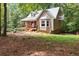 Charming home with a metal roof, inviting porch, and bay window, nestled among lush trees at 141 Mills Creek Path, Hiram, GA 30141