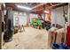 Spacious garage with ample storage space, work area, and various yard maintenance equipment at 141 Mills Creek Path, Hiram, GA 30141