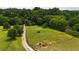 Lush acreage features green grass, mature trees and a winding driveway at 141 Mills Creek Path, Hiram, GA 30141