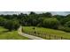 Lush acreage features green grass, mature trees and a winding driveway at 141 Mills Creek Path, Hiram, GA 30141