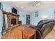 Inviting living room with stone fireplace, hardwood flooring, and comfortable leather seating at 141 Mills Creek Path, Hiram, GA 30141