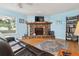 Cozy living room featuring a stone fireplace, hardwood floors, and a comfortable leather sofa at 141 Mills Creek Path, Hiram, GA 30141