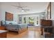 Sunlit bedroom with wood floors, bay window, and comfortable furnishings at 141 Mills Creek Path, Hiram, GA 30141