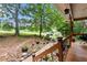 Scenic view from the porch with a stone path through the decorative yard, trees and driveway beyond at 141 Mills Creek Path, Hiram, GA 30141