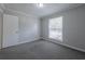 Bedroom with neutral walls, carpet, and a window at 2173 Martin Way, Jonesboro, GA 30236