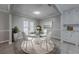 Dining room with glass table, modern chairs, tile floors, white wainscoting and view to backyard at 2173 Martin Way, Jonesboro, GA 30236