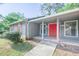 Welcoming covered front entrance with large red double doors and gray brick at 2173 Martin Way, Jonesboro, GA 30236