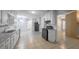 Well-lit kitchen with white cabinets, tile flooring, sleek black appliances, and ample counter space at 2173 Martin Way, Jonesboro, GA 30236
