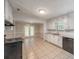 Open kitchen features white cabinets, tile floors, granite countertops, and a view to the backyard at 2173 Martin Way, Jonesboro, GA 30236