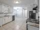 Bright kitchen with white cabinetry, tile flooring, granite countertops, and modern appliances at 2173 Martin Way, Jonesboro, GA 30236