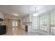 Spacious kitchen features plenty of cabinets, granite countertops, tile floors and a view to the backyard at 2173 Martin Way, Jonesboro, GA 30236
