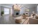 Staged living room with modern furniture, tile floors, fireplace and ample lighting at 2173 Martin Way, Jonesboro, GA 30236