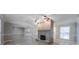 View of living room with a fireplace and tile flooring plus ceiling fans in open concept space at 2173 Martin Way, Jonesboro, GA 30236
