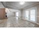 View of living room space with fireplace, ceiling fans, and open to kitchen with bright and neutral colors at 2173 Martin Way, Jonesboro, GA 30236