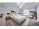 Modern main bedroom featuring neutral gray walls, carpet, ceiling fan, and a bright window view at 2173 Martin Way, Jonesboro, GA 30236