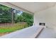 Covered outdoor patio featuring a brick fireplace and view of the backyard at 2991 Surrey Ln, Atlanta, GA 30341