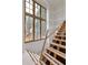 Unfinished staircase next to a large window with natural light at 2991 Surrey Ln, Atlanta, GA 30341