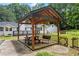 A covered picnic table and bench sits beside the pool, with home in background at 3345 Bomar Rd, Douglasville, GA 30135