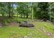 Backyard shot shows old merry-go-round in grassy and wooded area at 3345 Bomar Rd, Douglasville, GA 30135