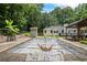 View of the covered pool surrounded by lush green trees and the home at 3345 Bomar Rd, Douglasville, GA 30135