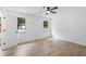 Spacious bedroom with wood floors, ceiling fan, and white walls at 3345 Bomar Rd, Douglasville, GA 30135