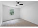 Cozy bedroom with neutral carpet, ceiling fan, and ample natural light at 3345 Bomar Rd, Douglasville, GA 30135