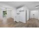 Bright dining area with wood floors, white cabinets, and adjacent laundry room at 3345 Bomar Rd, Douglasville, GA 30135