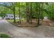 Wooded lot featuring a long drive leading to a beautiful house and separate storage shed at 3345 Bomar Rd, Douglasville, GA 30135