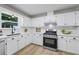 Bright kitchen with white cabinets, a stainless steel gas range, and modern countertops at 3345 Bomar Rd, Douglasville, GA 30135