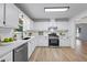 Updated kitchen featuring white cabinetry, stainless steel appliances, and subway tile backsplash at 3345 Bomar Rd, Douglasville, GA 30135