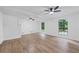 Bright living room with hardwood floors, exposed beams, a ceiling fan, and two large windows for great light at 3345 Bomar Rd, Douglasville, GA 30135